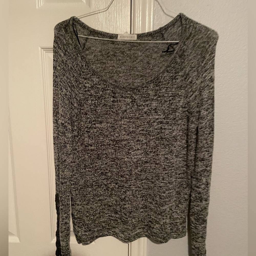 Aeropostal sweater with floral opening on the sleeves.